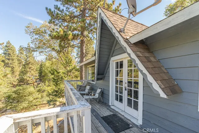 a view of balcony with wooden floor and fence
