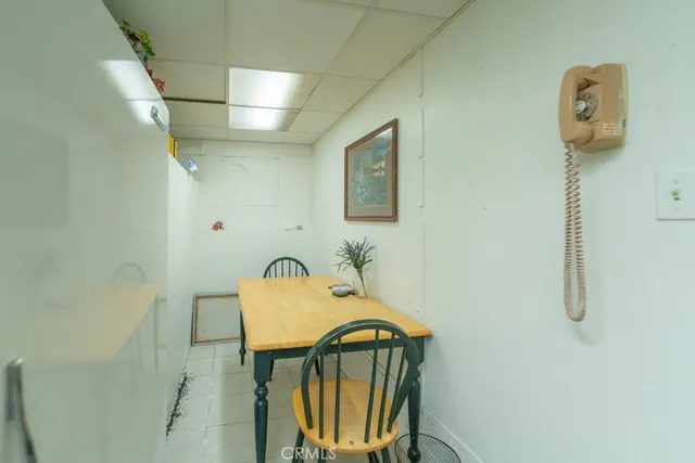a view of a livingroom with wooden floor and furniture
