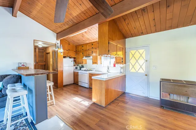 a kitchen with stainless steel appliances kitchen island granite countertop a stove a sink and a refrigerator