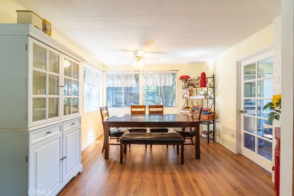 a dining room with furniture and wooden floor