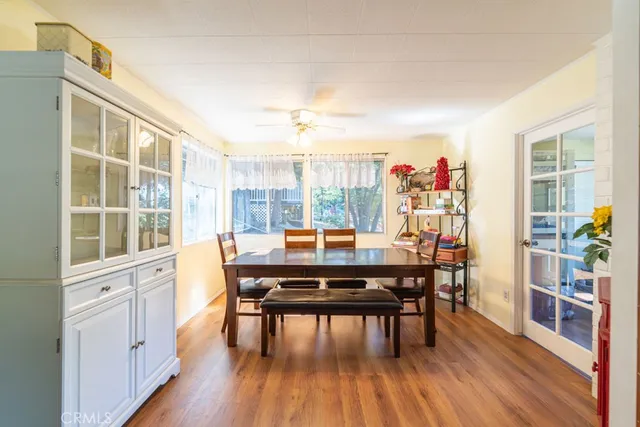 a dining room with furniture and wooden floor