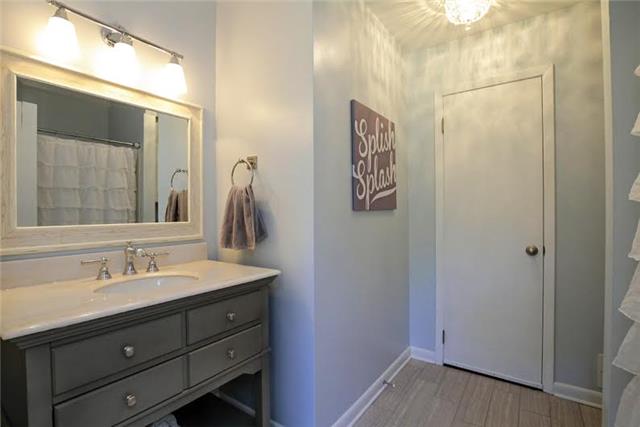 104 Ridgewood Road Franklin, TN 37064 - Photo 16 of 20 Another completely renovated bathroom. New flooring, mirror, sink, and vanity. Just off the bathroom is a huge walk-in storage space!