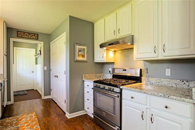 104 Ridgewood Road Franklin, TN 37064 - Photo 7 of 20 Stainless gas stove and hood. Off the kitchen is a spacious laundry room and hallway way and built-in coat rack. Pantry is wide with double doors, and has plenty of space.