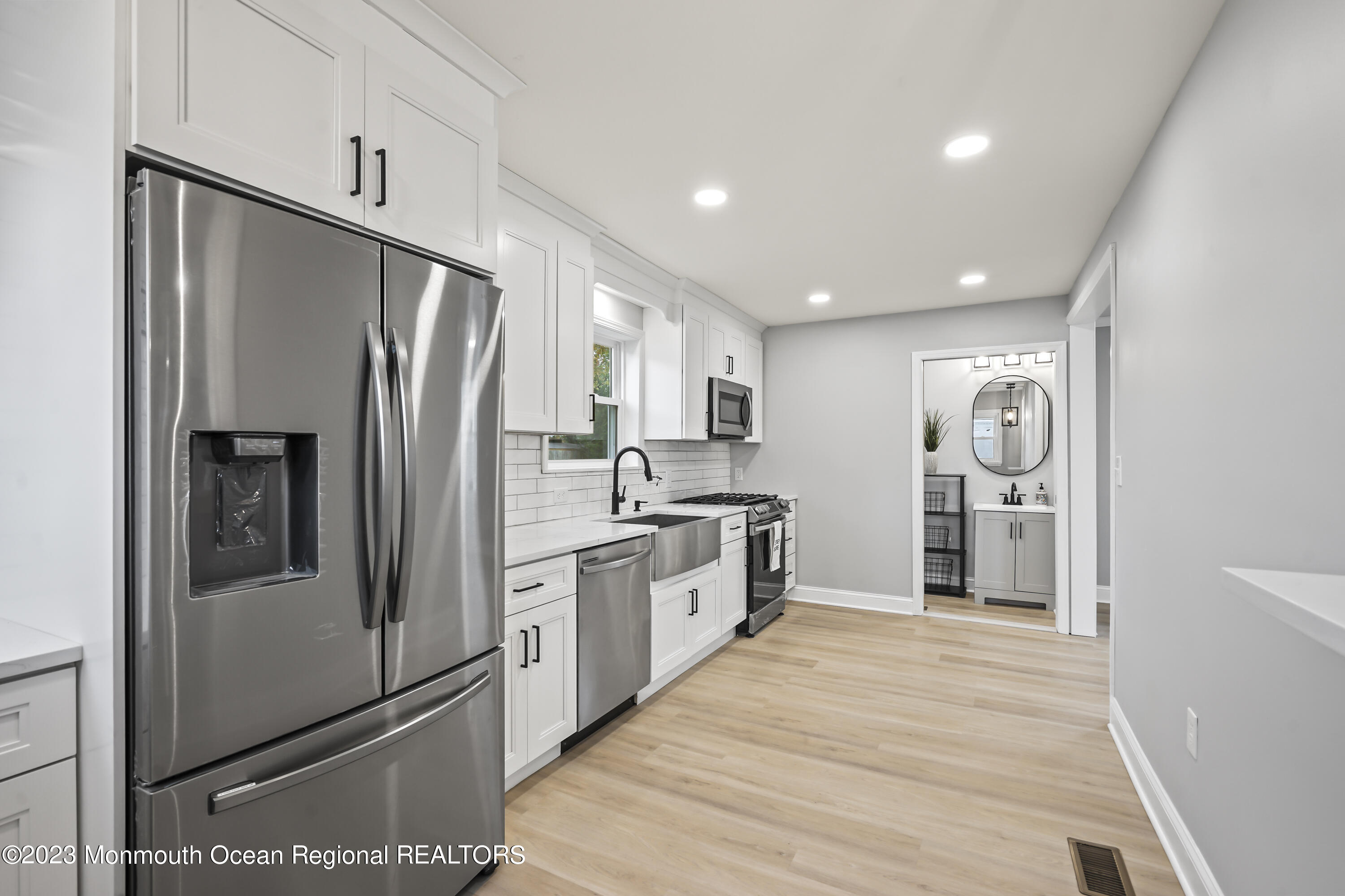 59 Ridge Avenue Neptune City, NJ 07753 - Photo 11 of 20 a kitchen with stainless steel appliances a refrigerator sink and cabinets