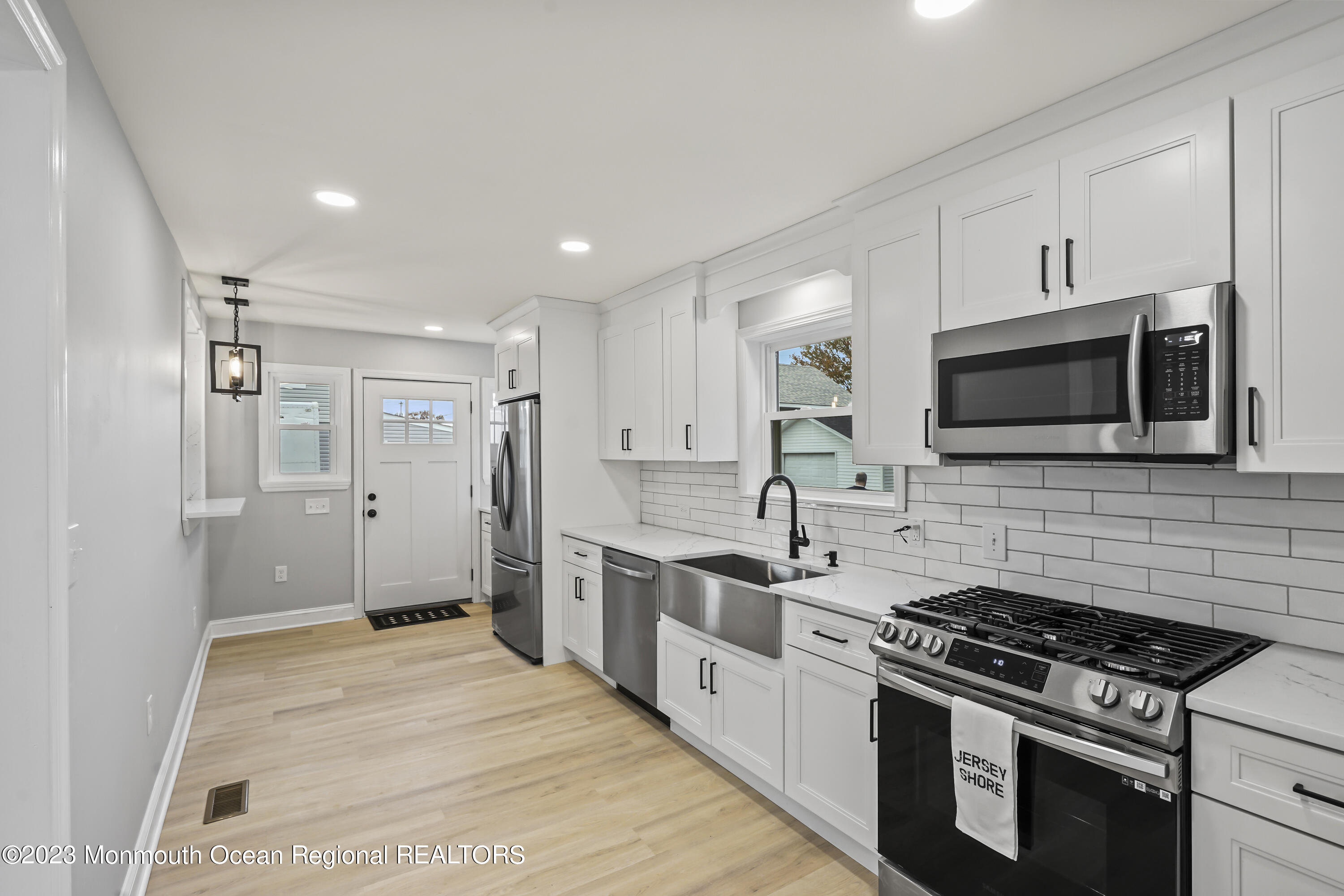 59 Ridge Avenue Neptune City, NJ 07753 - Photo 13 of 20 a kitchen with stainless steel appliances kitchen island granite countertop a stove and a sink