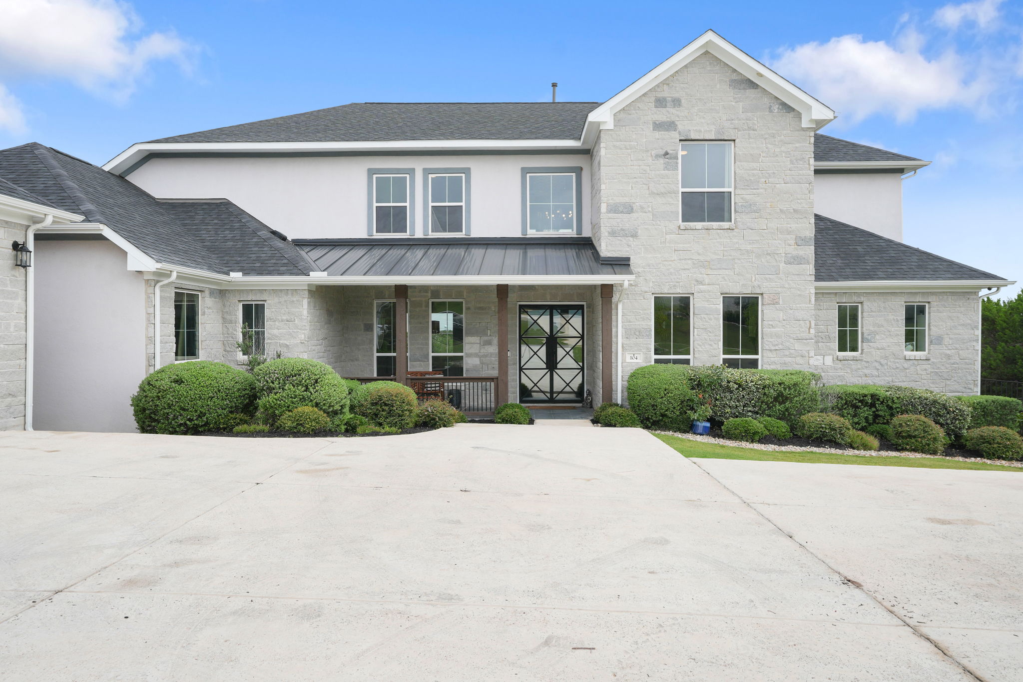 104 Lodestone Cove Austin, TX 78738 - Photo 40 of 40 Elegant stone and stucco exterior, graced with a meticulously manicured landscape, welcomes you home.