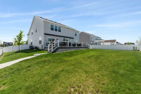 a view of a house with a yard and sitting area