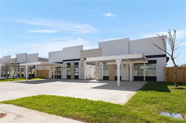 a view of a building with a yard