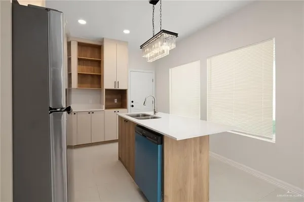 a kitchen with a sink a stove a refrigerator and cabinets