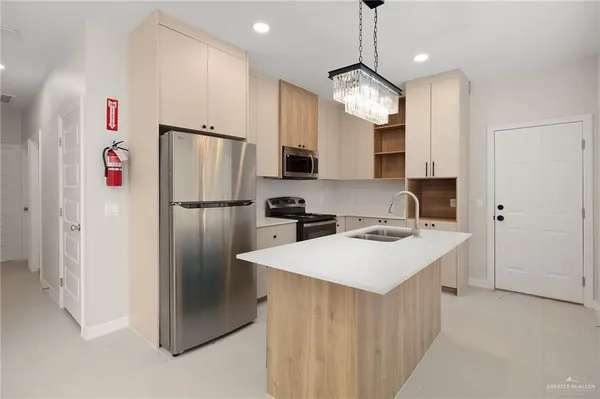 a kitchen with refrigerator a sink and a refrigerator