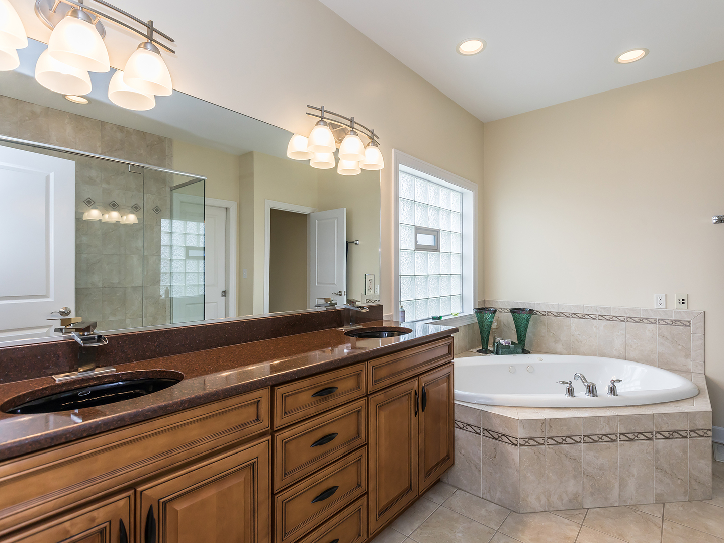 3N480 Fair Oaks Road West Chicago, IL 60185 - Photo 11 of 25 a bathroom with a granite countertop bathtub sink and mirror