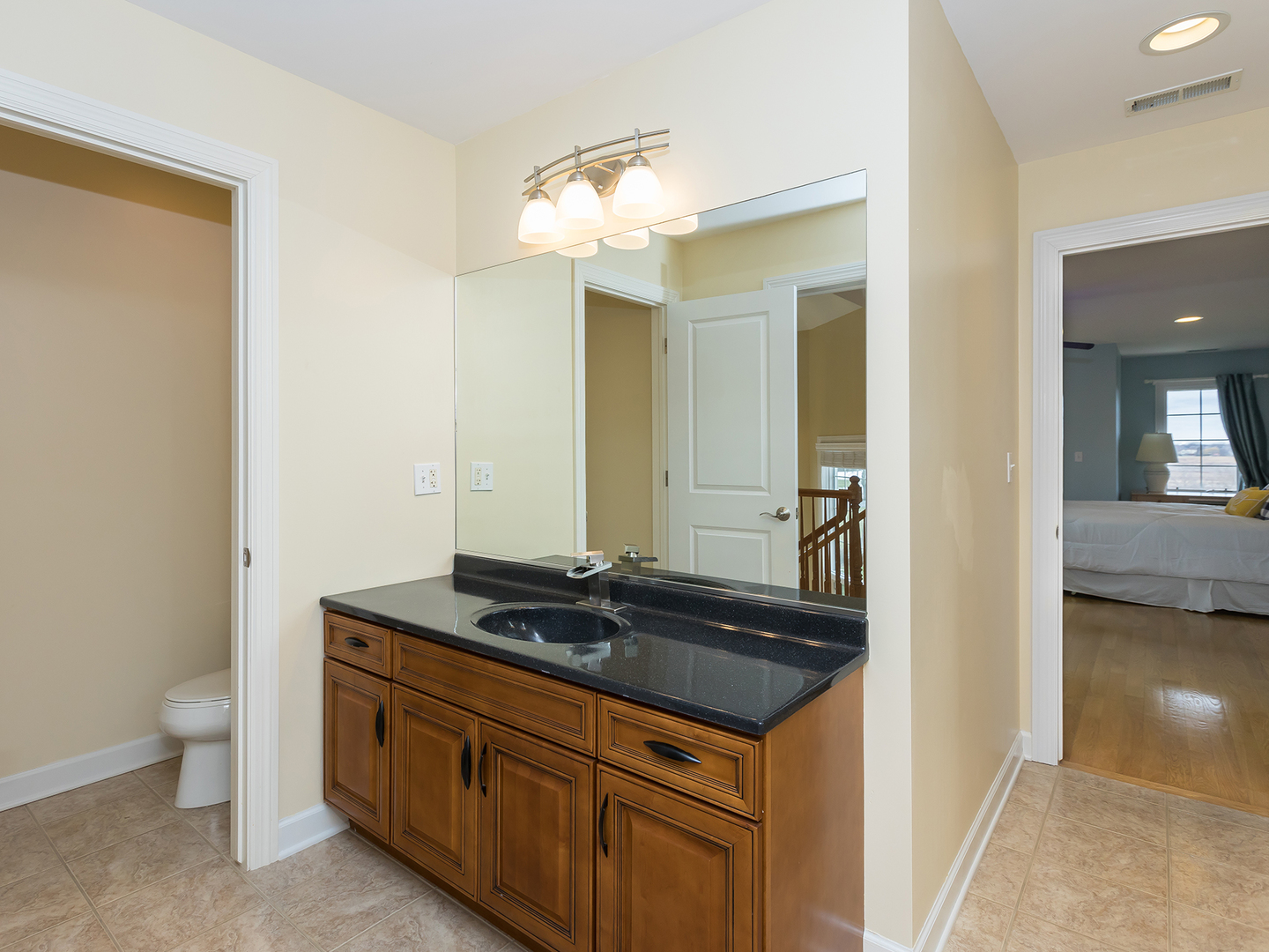 3N480 Fair Oaks Road West Chicago, IL 60185 - Photo 16 of 25 a bathroom with a granite countertop sink a toilet and a mirror