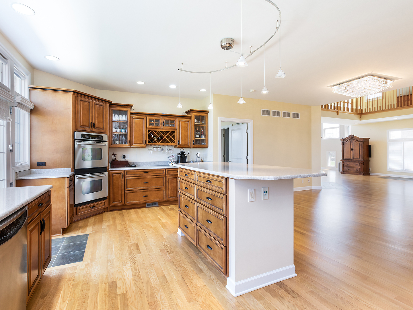 3N480 Fair Oaks Road West Chicago, IL 60185 - Photo 6 of 25 a kitchen with stainless steel appliances kitchen island granite countertop a stove a sink a refrigerator and a microwave