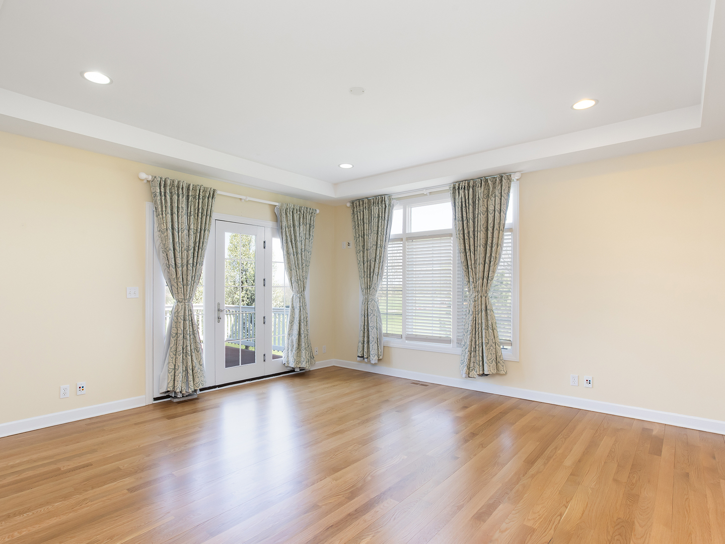 3N480 Fair Oaks Road West Chicago, IL 60185 - Photo 10 of 25 an empty room with wooden floor and windows with curtains