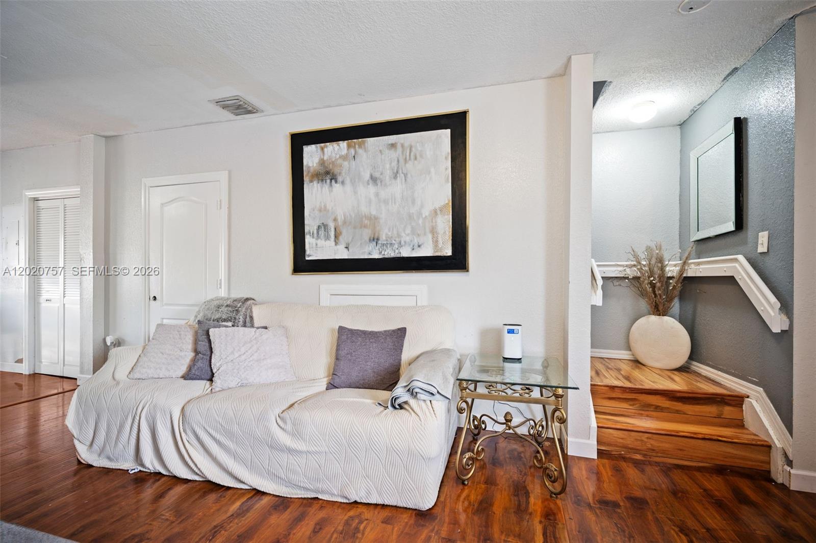 255 East 3rd Street, Unit 1 Hialeah, FL 33010 - Photo 10 of 38 a bedroom with a bed and wooden floor