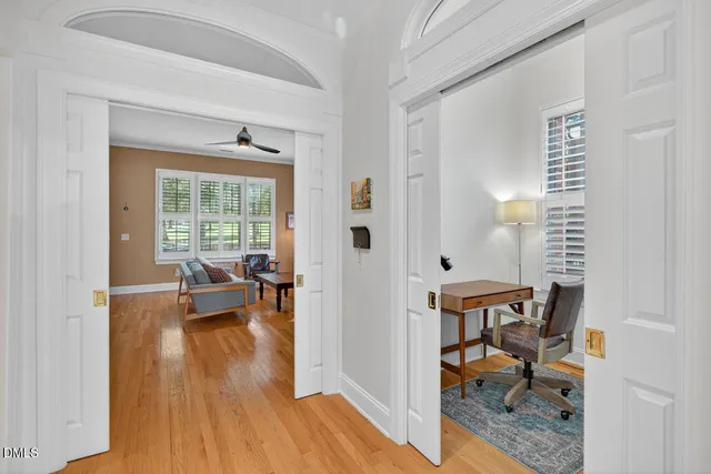 a view of a workspace with furniture and a book shelf