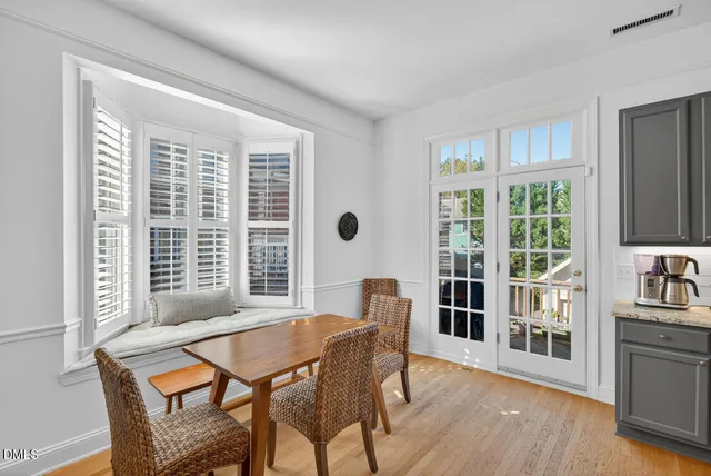 a kitchen with kitchen island granite countertop a sink cabinets a refrigerator and wooden cabinets