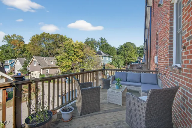 a balcony with wooden floor and furniture