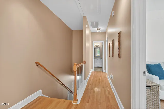 a spacious bedroom with a bed and wooden floor
