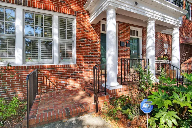 front view of a brick house with a large windows