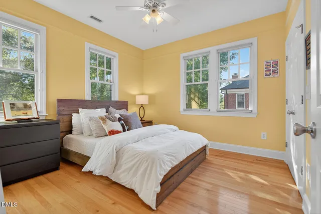 a bedroom with a bed and wooden floor