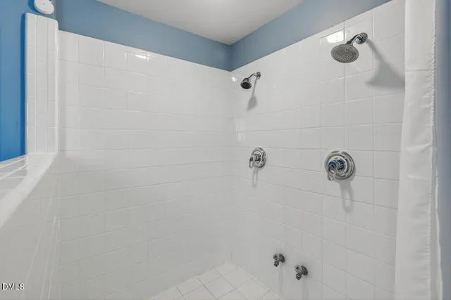 a bathroom with a bathtub and a picture on the wall