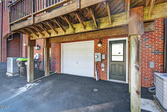 a view of a street with a building and trees