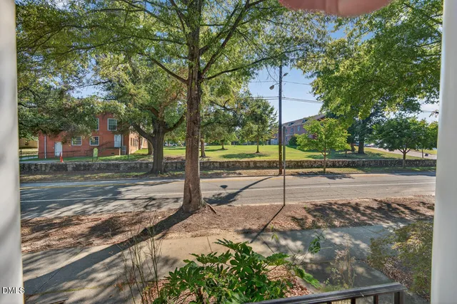 a view of a porch with a floor to ceiling window next to a yard