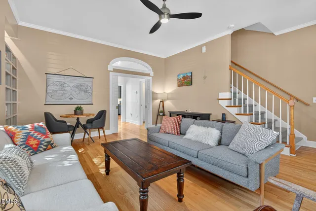a living room with furniture and a wooden floor