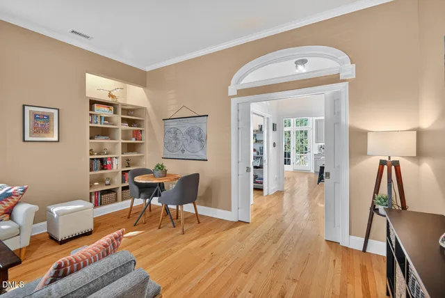 a living room with furniture and wooden floor