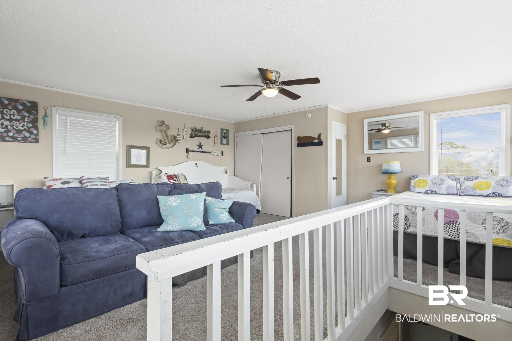 562 Veterans Road Gulf Shores, AL 36542 - Photo 27 of 32 Carpeted living room featuring ceiling fan and ornamental molding
