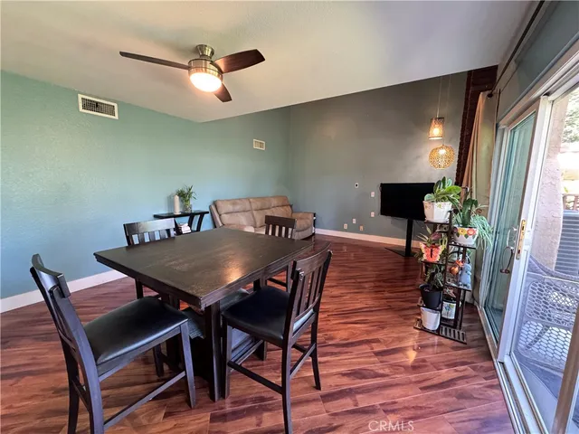 a view of a dining room with furniture and a window