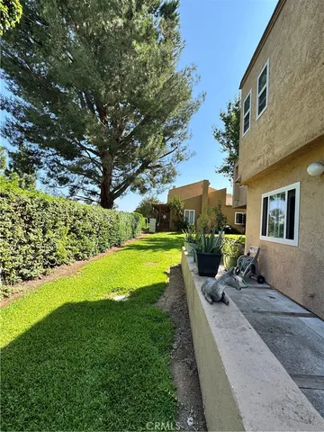 a view of a house with backyard sitting area and garden