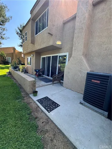 a view of a couches and dinning table in patio of a house