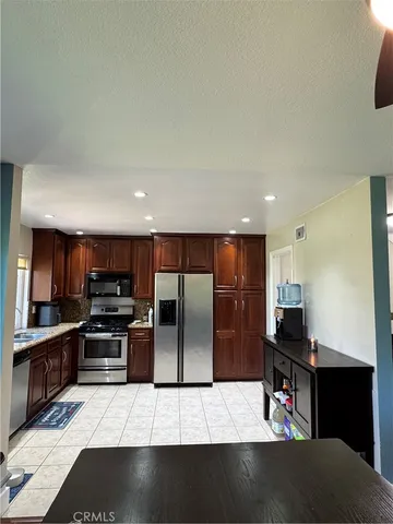 a kitchen with refrigerator and a counter top space