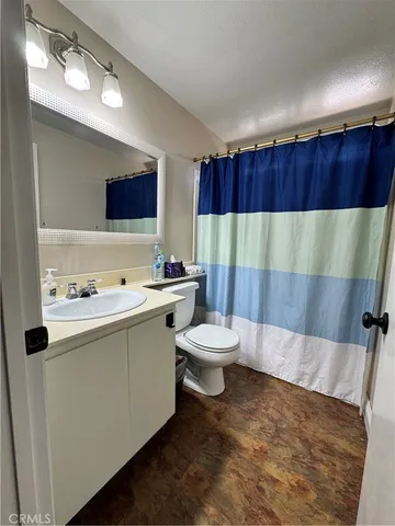 a bathroom with a sink a toilet and mirror