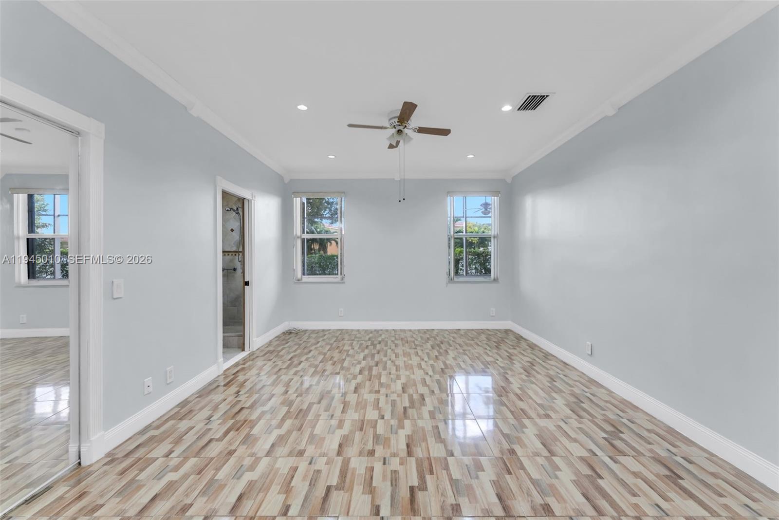 13296 Southwest 54th Court Miramar, FL 33027 - Photo 11 of 34 wooden floor in an empty room with a window