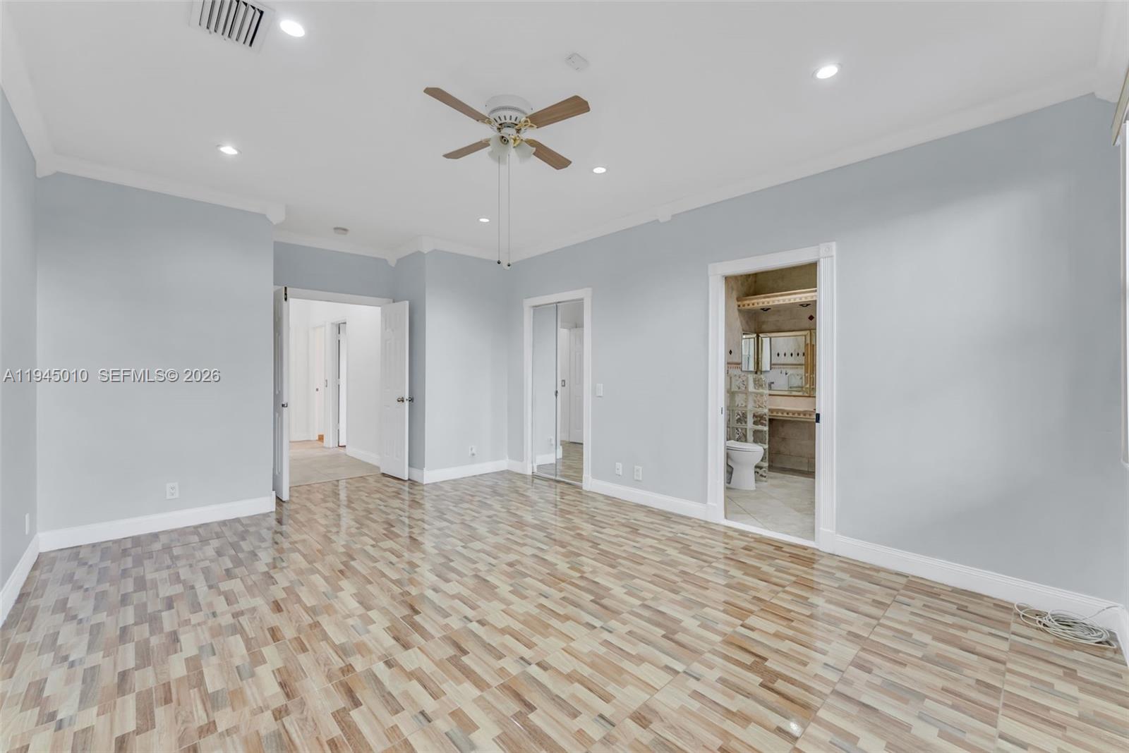 13296 Southwest 54th Court Miramar, FL 33027 - Photo 12 of 34 a view of empty room with wooden floor and ceiling fan