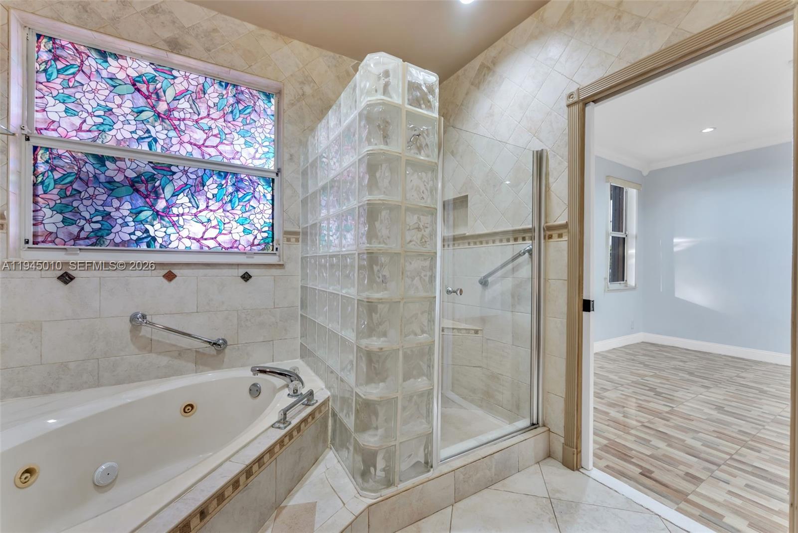 13296 Southwest 54th Court Miramar, FL 33027 - Photo 15 of 34 a bathroom with a tub shower and sink