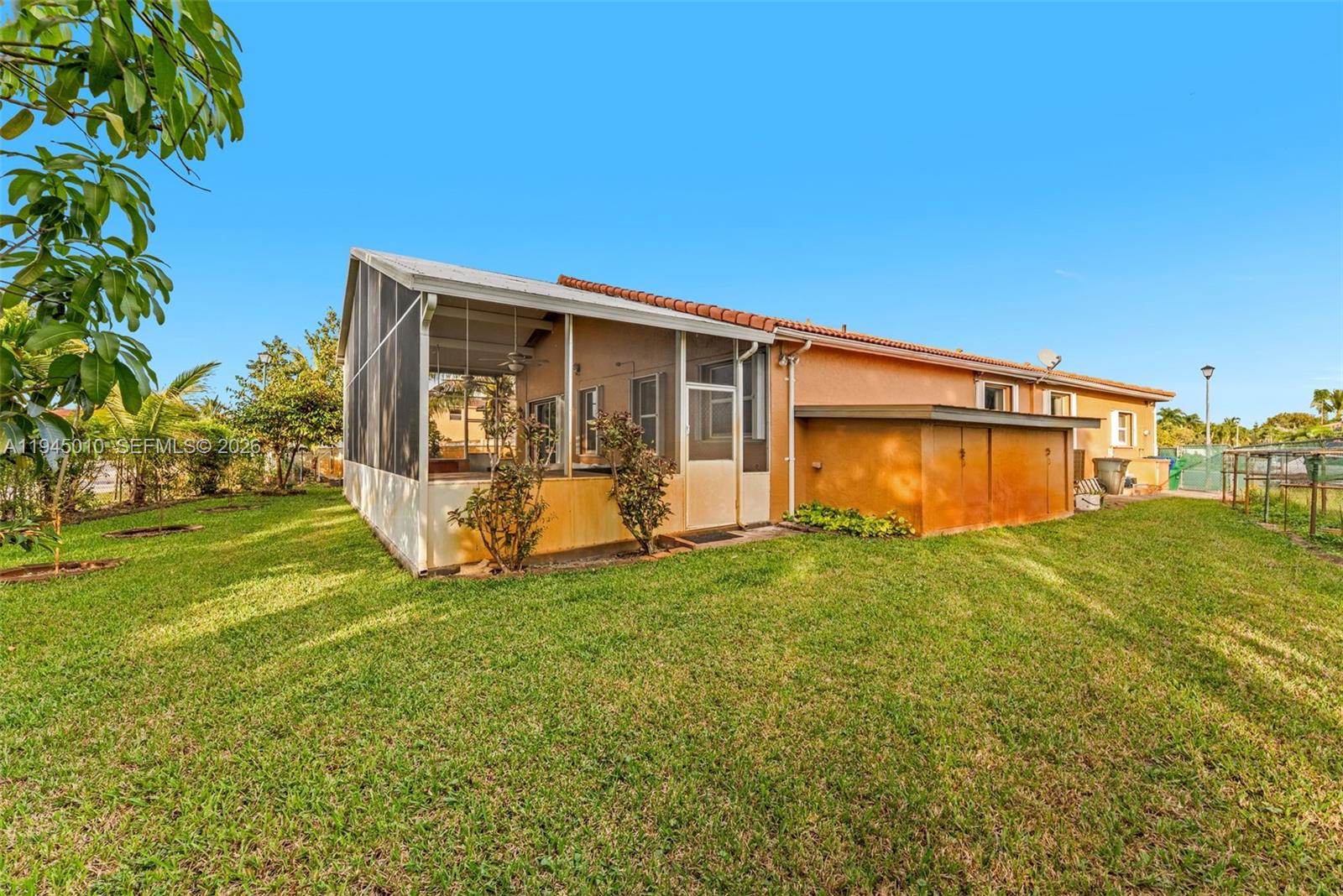 13296 Southwest 54th Court Miramar, FL 33027 - Photo 16 of 34 a view of a backyard with plants and large trees