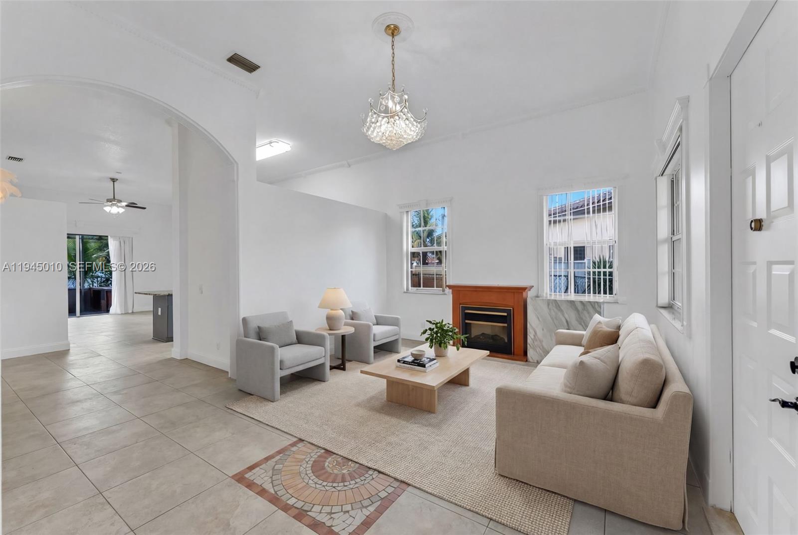 13296 Southwest 54th Court Miramar, FL 33027 - Photo 24 of 34 a living room with furniture a fireplace and a chandelier