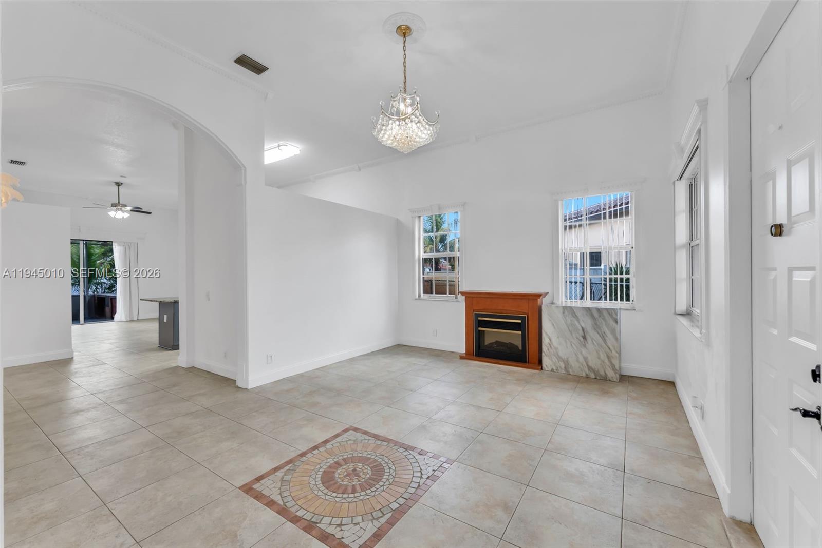 13296 Southwest 54th Court Miramar, FL 33027 - Photo 25 of 34 a view of a livingroom with furniture and chandelier fan
