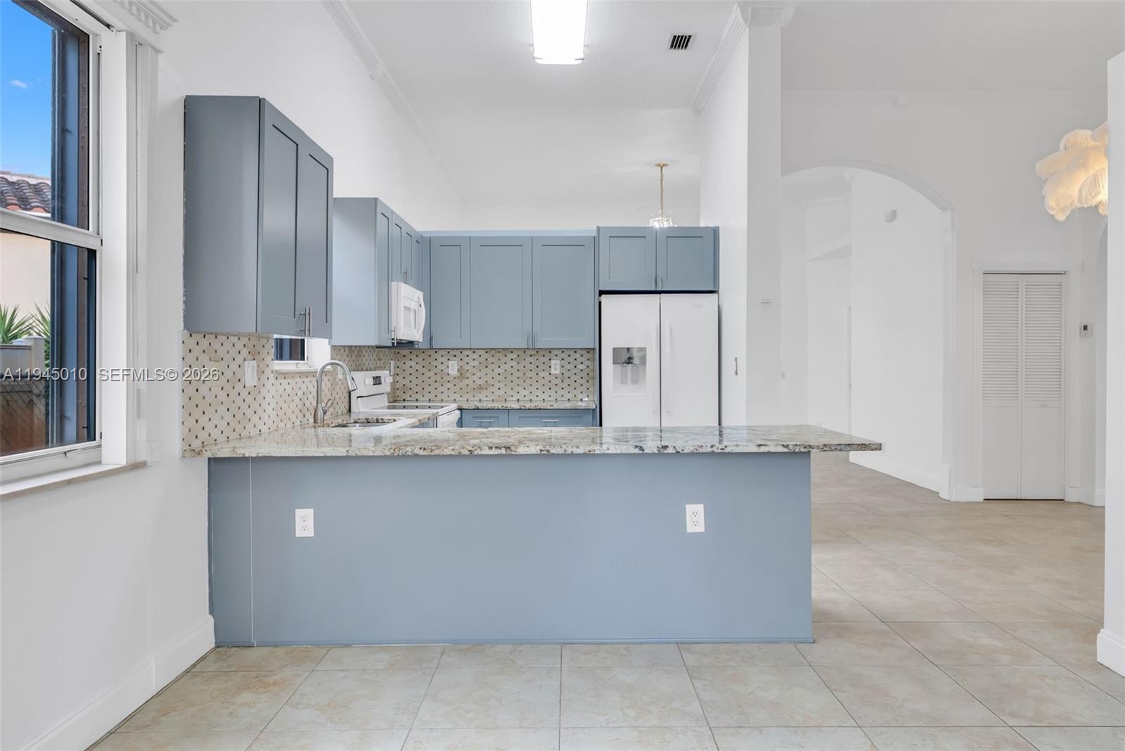13296 Southwest 54th Court Miramar, FL 33027 - Photo 31 of 34 a kitchen with stainless steel appliances granite countertop a sink counter space and cabinets