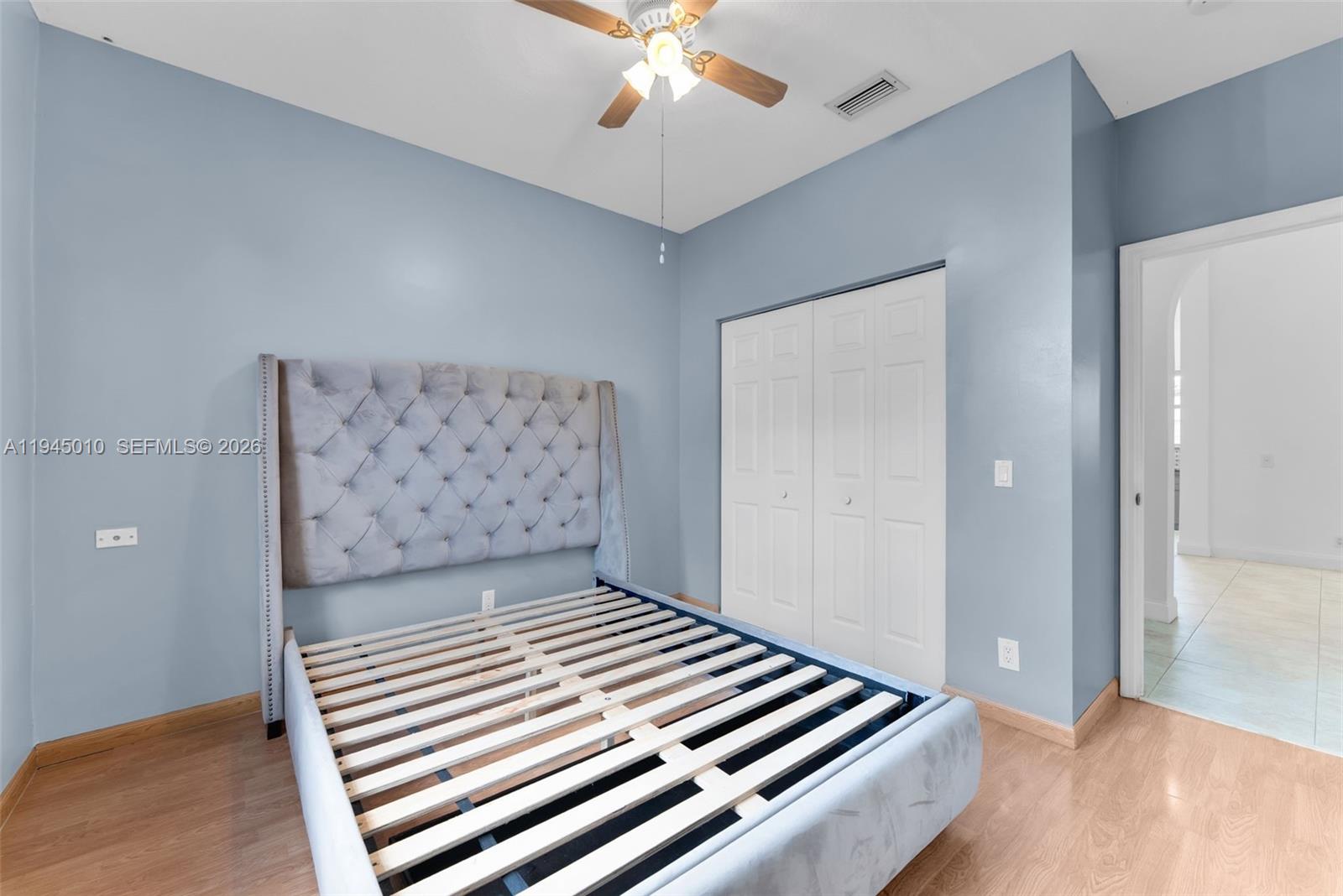 13296 Southwest 54th Court Miramar, FL 33027 - Photo 9 of 34 a bedroom with a bed and a chandelier