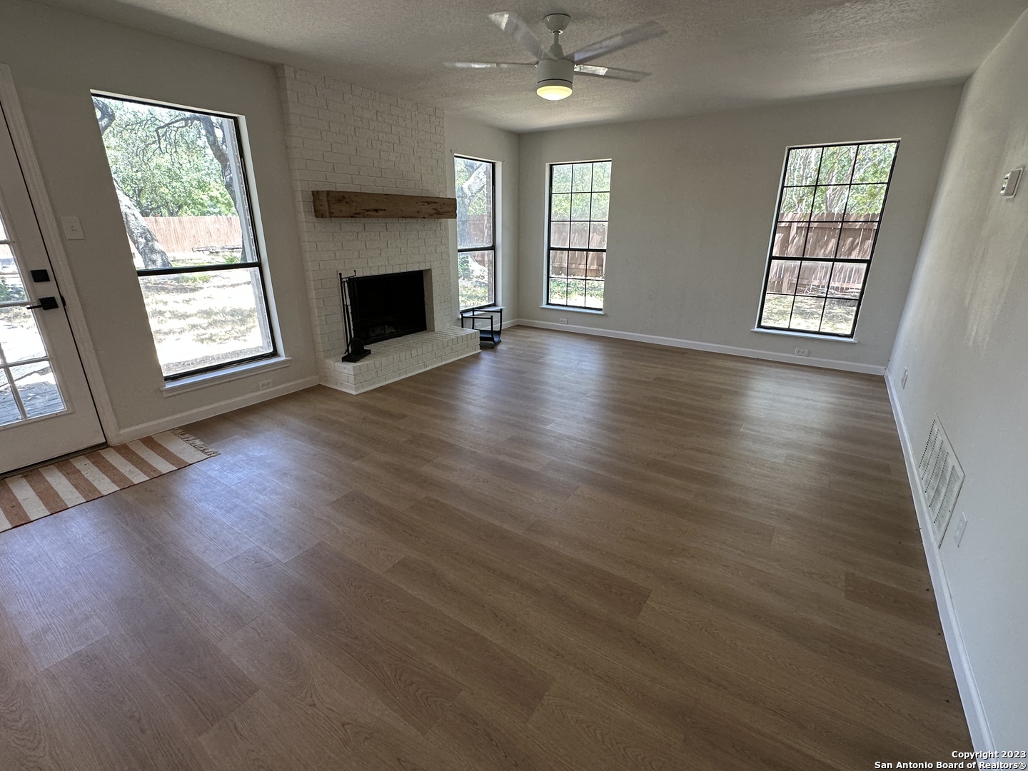 1722 Encino Spring San Antonio, TX 78259 - Photo 11 of 55 an empty room with wooden floor fireplace and windows