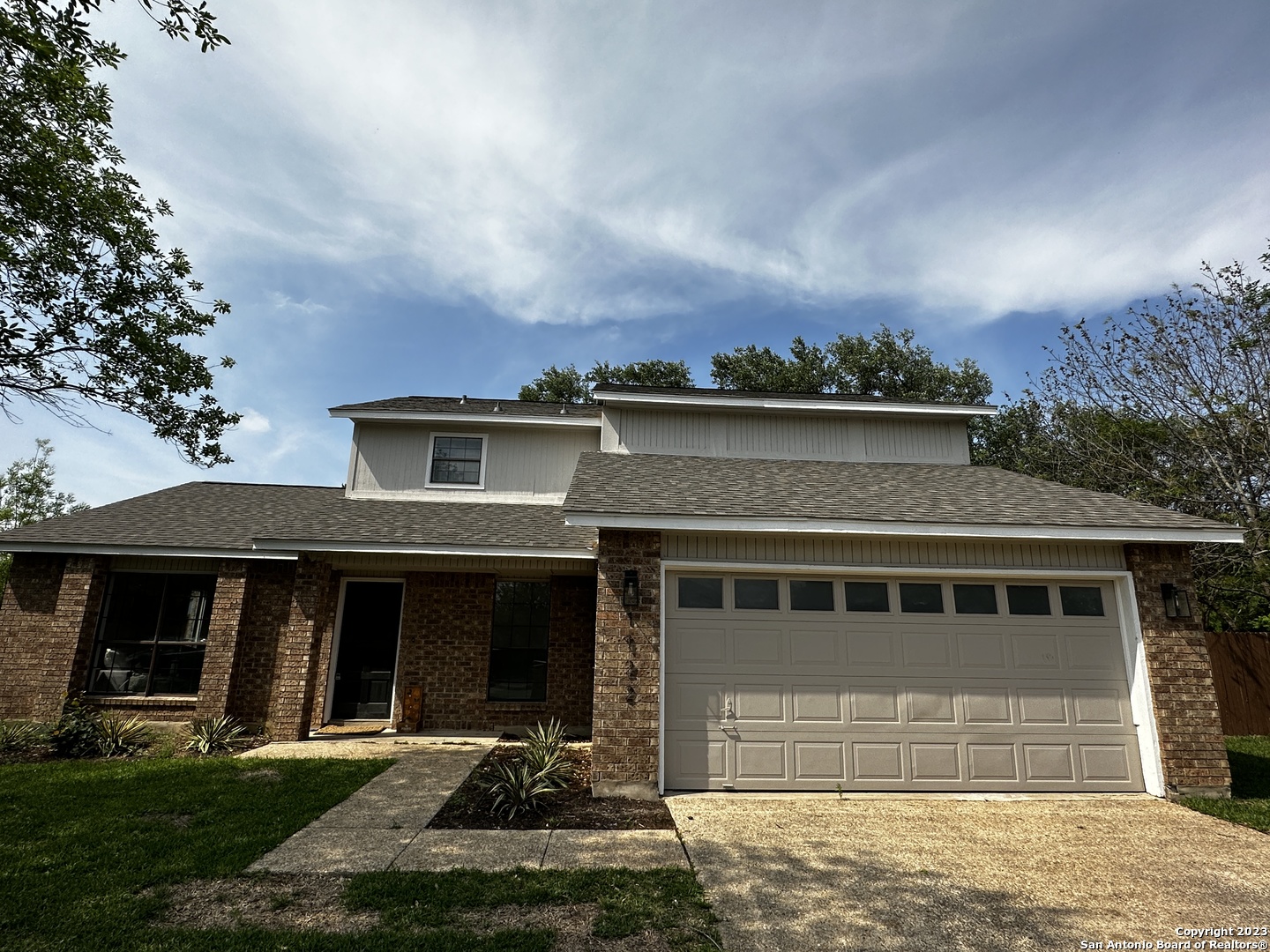 1722 Encino Spring San Antonio, TX 78259 - Photo 2 of 55 a front view of a house with a yard and garage