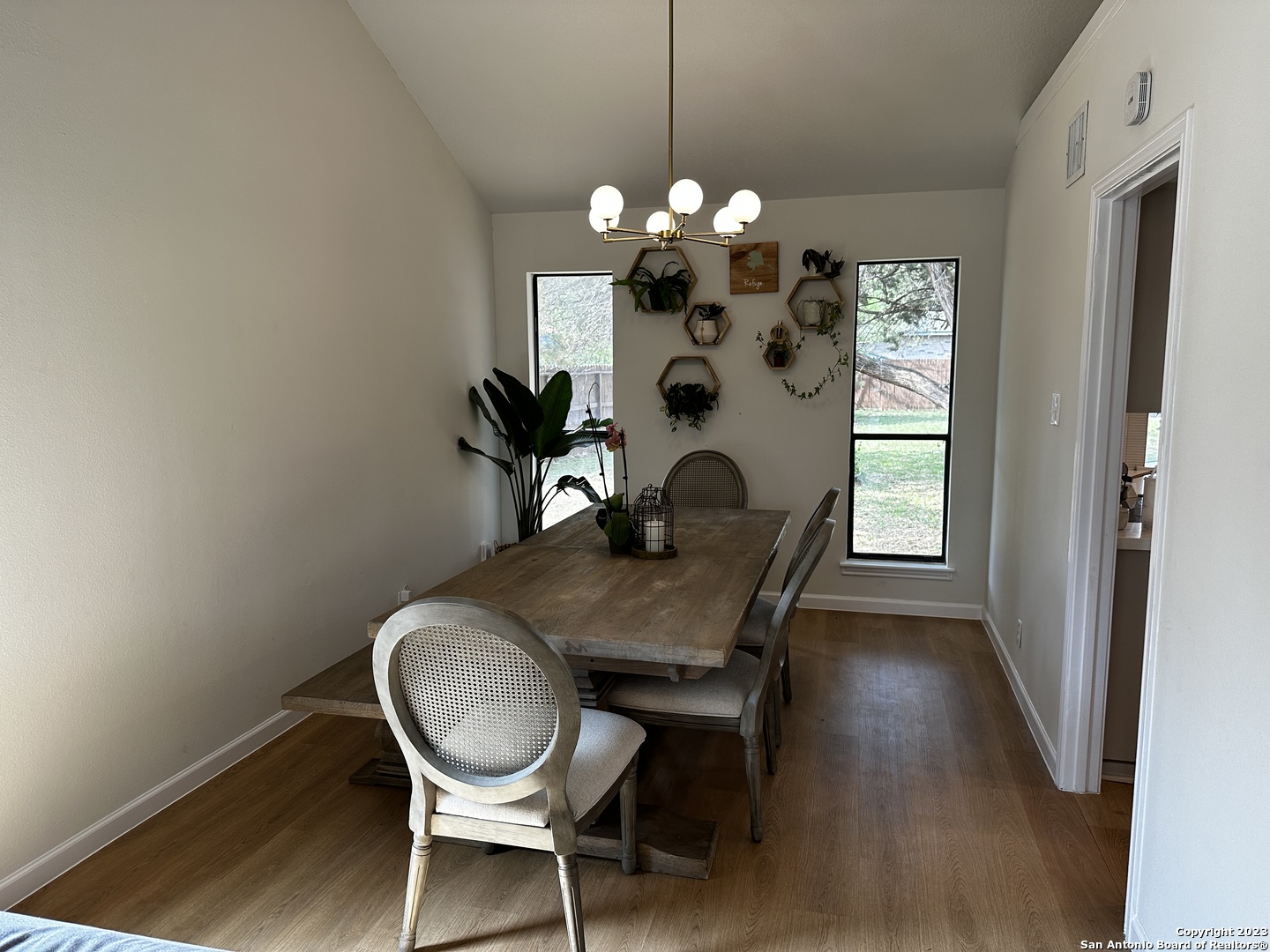 1722 Encino Spring San Antonio, TX 78259 - Photo 25 of 55 a dining room with furniture a chandelier and wooden floor