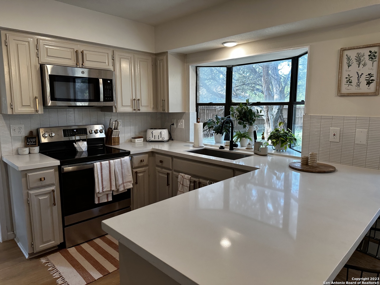 1722 Encino Spring San Antonio, TX 78259 - Photo 33 of 55 a kitchen with stainless steel appliances a microwave sink and cabinets