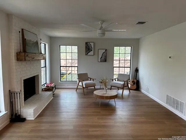 a spacious bedroom with a bed and ceiling fan