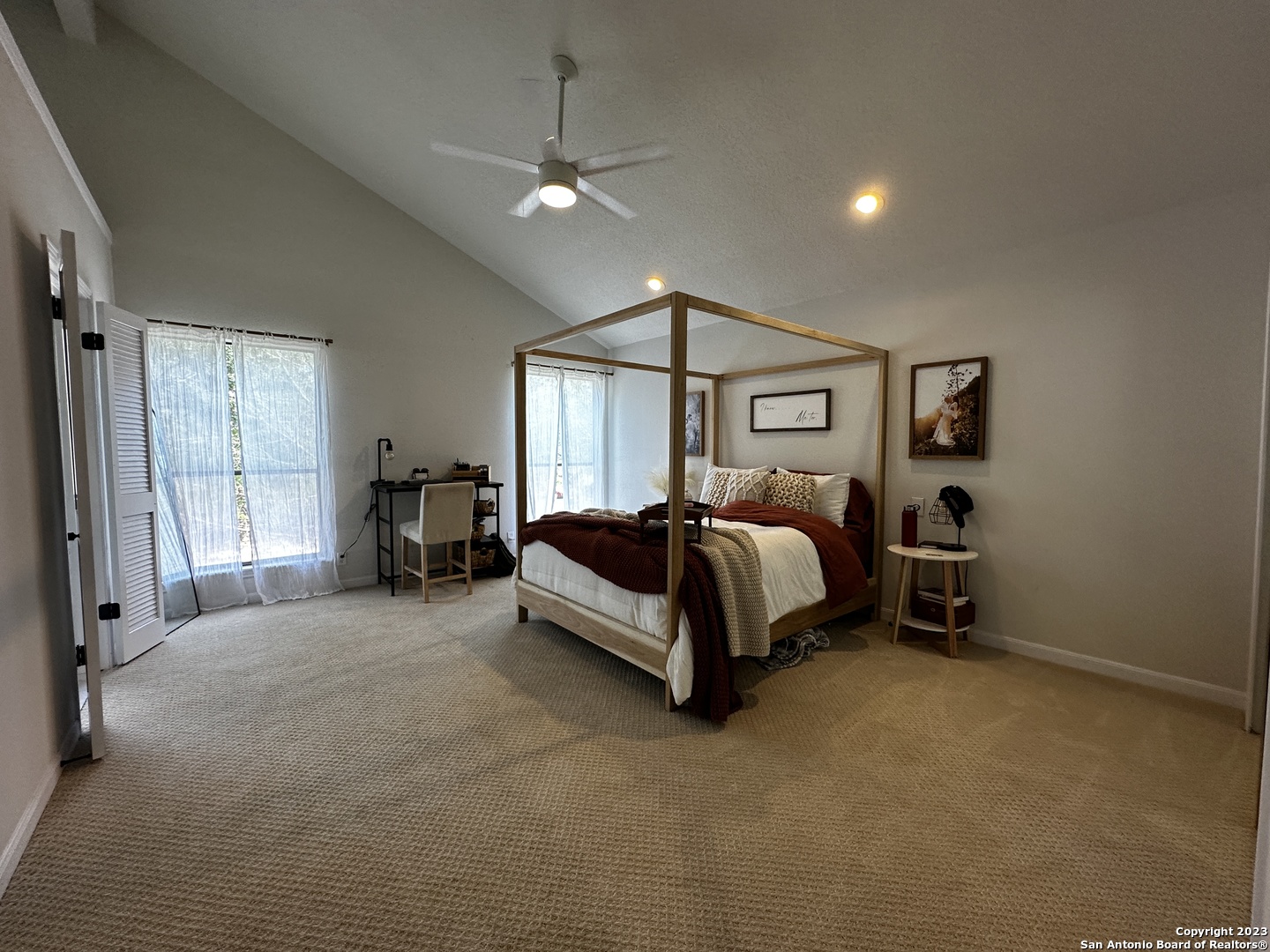 1722 Encino Spring San Antonio, TX 78259 - Photo 40 of 55 a spacious bedroom with a bed a chandelier and a window
